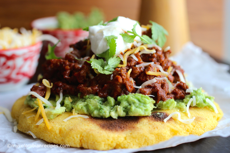 Arepas with Beef Chili, Guacamole and Cheese |mycolombianrecipes.com