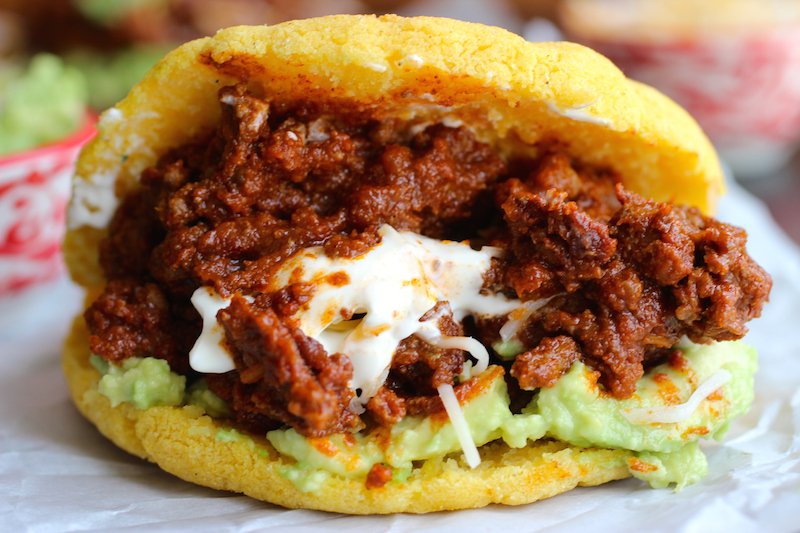 Arepas with Beef Chili, Guacamole and Cheese |mycolombianrecipes.com