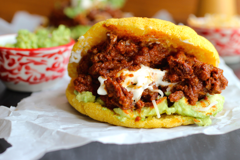Arepas with Beef Chili, Guacamole and Cheese |mycolombianrecipes.com